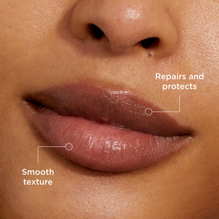 The image focuses on lips, showcasing a product designed to enhance lip health. Key benefits highlighted are:
Smooth texture: the product leaves lips feeling soft and even.
Repairs and protects: Indicates it helps restore damaged lips while providing a protective barrier.
The close-up emphasises the product’s effectiveness in delivering visible hydration and nourishment.